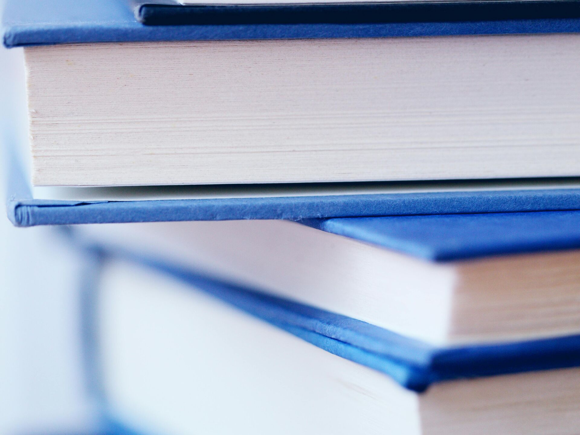 Nahaufnahme eines Stapels Bücher mit blauen Einbänden.